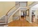 A grand two-story foyer with a curved staircase and hardwood floors at 1442 Swiftwater Cir, Mcdonough, GA 30252