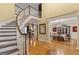 Grand foyer featuring a curved staircase, gleaming hardwood floors, and elegant architectural details at 1442 Swiftwater Cir, Mcdonough, GA 30252