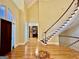 Spacious foyer with hardwood floors, staircase, a decorative tile inlay, and access to a home office at 1442 Swiftwater Cir, Mcdonough, GA 30252