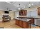 Open kitchen design with a central island, chandeliers, built-in appliances, and adjacent dining area at 1442 Swiftwater Cir, Mcdonough, GA 30252