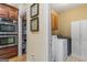 Convenient laundry area near a pantry, complete with appliances and cabinet storage at 1442 Swiftwater Cir, Mcdonough, GA 30252