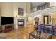 Comfortable living room with hardwood floors, fireplace, views of the staircase and dining area at 1442 Swiftwater Cir, Mcdonough, GA 30252