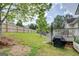 Large, fenced backyard with lush green grass and a wooden deck, perfect for outdoor gatherings at 1484 Stephens Pond Vw, Loganville, GA 30052