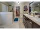 Bright bathroom features a glass shower, double vanity with marble top, and walk-in closet access at 1484 Stephens Pond Vw, Loganville, GA 30052