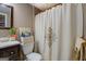 Bathroom showcasing the decorative shower curtain and neutral color scheme, enhancing a calm ambiance at 1484 Stephens Pond Vw, Loganville, GA 30052