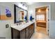 Bathroom with double sink vanity, dark wood cabinets, and stylish lighting at 1484 Stephens Pond Vw, Loganville, GA 30052