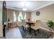 Dining room with hardwood floors, stylish rug, and large window at 1484 Stephens Pond Vw, Loganville, GA 30052