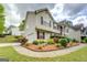 A two-story home showcasing landscaped grounds and a side-entry garage, nestled in a suburban setting at 1484 Stephens Pond Vw, Loganville, GA 30052