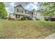 View of two-story home with lush front lawn and landscaped garden at 1484 Stephens Pond Vw, Loganville, GA 30052