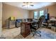 Home office area offering plenty of natural light with a ceiling fan, creating a productive workspace at 1484 Stephens Pond Vw, Loganville, GA 30052