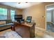 Spacious home office features a comfortable seating area, large desk, and plenty of natural light at 1484 Stephens Pond Vw, Loganville, GA 30052