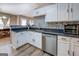 Well-lit kitchen featuring granite countertops, stainless steel appliances, and stylish mosaic backsplash at 1484 Stephens Pond Vw, Loganville, GA 30052