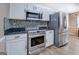 Kitchen with stainless steel appliances including refrigerator, microwave, and oven at 1484 Stephens Pond Vw, Loganville, GA 30052