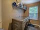 Laundry room with modern, high-efficiency washer and dryer, plus convenient shelving for supplies at 1484 Stephens Pond Vw, Loganville, GA 30052