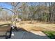 A spacious backyard features mature trees, offering a serene outdoor living space and natural beauty at 55 Helen Ln, Stockbridge, GA 30281
