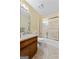 Bathroom with a wood vanity, sink, toilet, and glass door shower and tub combination at 55 Helen Ln, Stockbridge, GA 30281