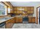 Kitchen featuring wooden cabinets, laminate countertops, and modern appliances at 55 Helen Ln, Stockbridge, GA 30281
