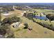 Expansive property featuring a home, pond, and sprawling green fields, offering a serene rural lifestyle at 1092 E Lake Rd, Mcdonough, GA 30252