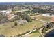Panoramic view of a property with mature trees, open fields, and a calm pond, perfect for nature lovers at 1092 E Lake Rd, Mcdonough, GA 30252