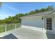 This shot shows a private outdoor space with the grey deck and pastoral landscape views at 1092 E Lake Rd, Mcdonough, GA 30252