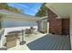 This photo highlights an outdoor living space with patio seating, and the home's brick exterior at 1092 E Lake Rd, Mcdonough, GA 30252