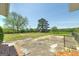 View from the back patio showcasing the expansive backyard, mature trees, and chainlink fencing at 1092 E Lake Rd, Mcdonough, GA 30252