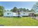 Backyard featuring a spacious deck, lush greenery, and fencing for privacy at 1092 E Lake Rd, Mcdonough, GA 30252