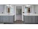 Bathroom with dual sink vanity, and framed mirrors, offering a seamless transition to the adjacent bedroom at 1092 E Lake Rd, Mcdonough, GA 30252
