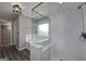 Modern bathroom offers a glass-enclosed shower with seating, complemented by a soaking tub beneath a window at 1092 E Lake Rd, Mcdonough, GA 30252