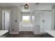 Modern bathroom features a glass-enclosed shower, and a luxurious soaking tub under a bright window at 1092 E Lake Rd, Mcdonough, GA 30252