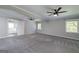 Spacious bedroom featuring neutral gray walls, plush gray carpet, and dual ceiling fans for optimal comfort at 1092 E Lake Rd, Mcdonough, GA 30252
