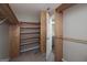 Spacious walk-in closet with custom wood shelving, providing ample storage and organization solutions at 1092 E Lake Rd, Mcdonough, GA 30252