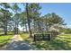Long paved driveway lined with trees and a black fence, leading to a house in the distance at 1092 E Lake Rd, Mcdonough, GA 30252