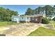 This exterior shot showcases the home's brick and white siding, complemented by a concrete driveway and lush greenery at 1092 E Lake Rd, Mcdonough, GA 30252