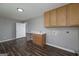 Functional laundry room boasts modern laminate flooring, a sink, and lots of cabinet storage at 1092 E Lake Rd, Mcdonough, GA 30252