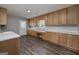 Dedicated laundry room with laminate floor, lots of cabinet space, and natural light at 1092 E Lake Rd, Mcdonough, GA 30252
