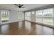 Bright living room with hardwood floors, neutral paint, and three large windows bringing in plenty of natural light at 1092 E Lake Rd, Mcdonough, GA 30252