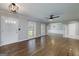 Bright living room with hardwood floors, featuring a ceiling fan and an open archway into another room at 1092 E Lake Rd, Mcdonough, GA 30252