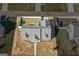 Overhead aerial view of the property featuring a gray roof and white picket fence at 1141 Abundance Dr, Locust Grove, GA 30248