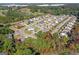 An aerial shot of an attractive suburban neighborhood bordered by lush trees with fall colors in the landscape at 1141 Abundance Dr, Locust Grove, GA 30248