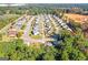 An aerial view showcases a well-maintained neighborhood with sidewalks, mature trees, and construction in the background at 1141 Abundance Dr, Locust Grove, GA 30248