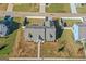 Aerial image of the home featuring a gray roof and white picket fence at 1141 Abundance Dr, Locust Grove, GA 30248