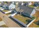 Aerial shot of the property featuring a spacious backyard with a white picket fence at 1141 Abundance Dr, Locust Grove, GA 30248