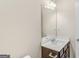 Bright bathroom has a large mirror, vanity with a sink and cabinet, and neutral wall color at 1141 Abundance Dr, Locust Grove, GA 30248