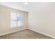 Bedroom with a light neutral color scheme, carpeted floors, and a large window at 1141 Abundance Dr, Locust Grove, GA 30248