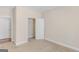 Neutral bedroom boasts a carpeted floor, closet, white doors, and light-colored walls at 1141 Abundance Dr, Locust Grove, GA 30248