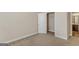 Bedroom featuring carpet, white walls, walk-in closet, and ensuite bathroom access at 1141 Abundance Dr, Locust Grove, GA 30248