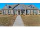 Charming single-story home featuring a brick facade, dormer windows, and well-maintained landscaping at 1141 Abundance Dr, Locust Grove, GA 30248