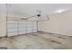 Spacious two-car garage with concrete floor and white sectional garage door at 1141 Abundance Dr, Locust Grove, GA 30248