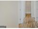 Hallway featuring wood floors, white trim, and a view into walk-in closet at 1141 Abundance Dr, Locust Grove, GA 30248